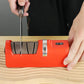 Person sharpening a knife with a red electric knife sharpener on a wooden surface, clarioy auto tools homeware